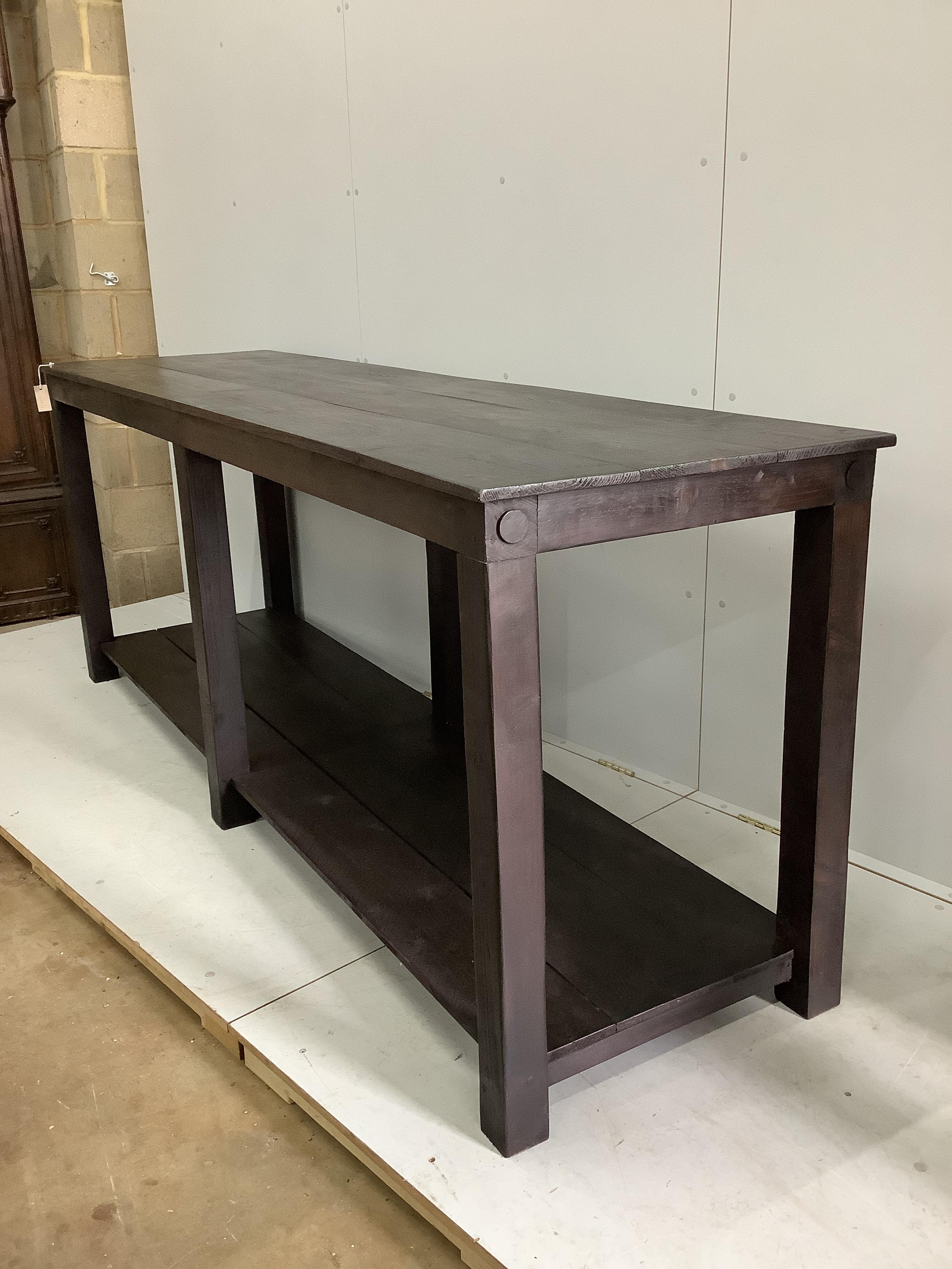 A stained pine rectangular draper's table, width 240cm, depth 67cm, height 92cm